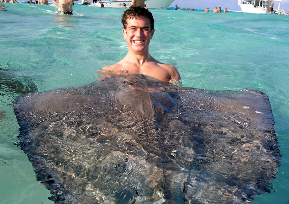 Sam swimming with Stingrays in Cayman